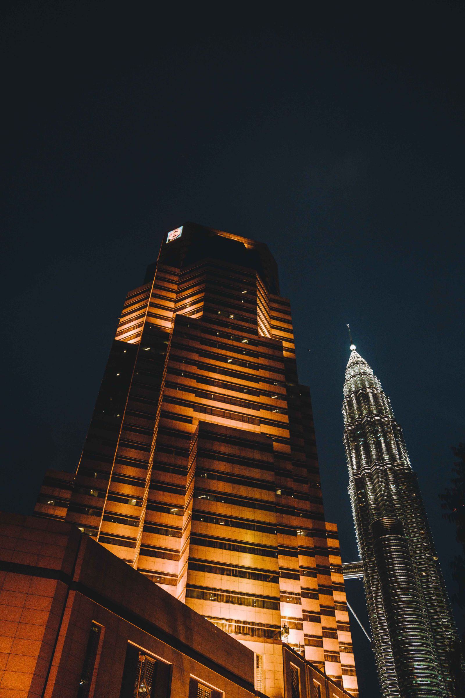 Illuminated golden skyscrapers of Kuala Lumpur at night