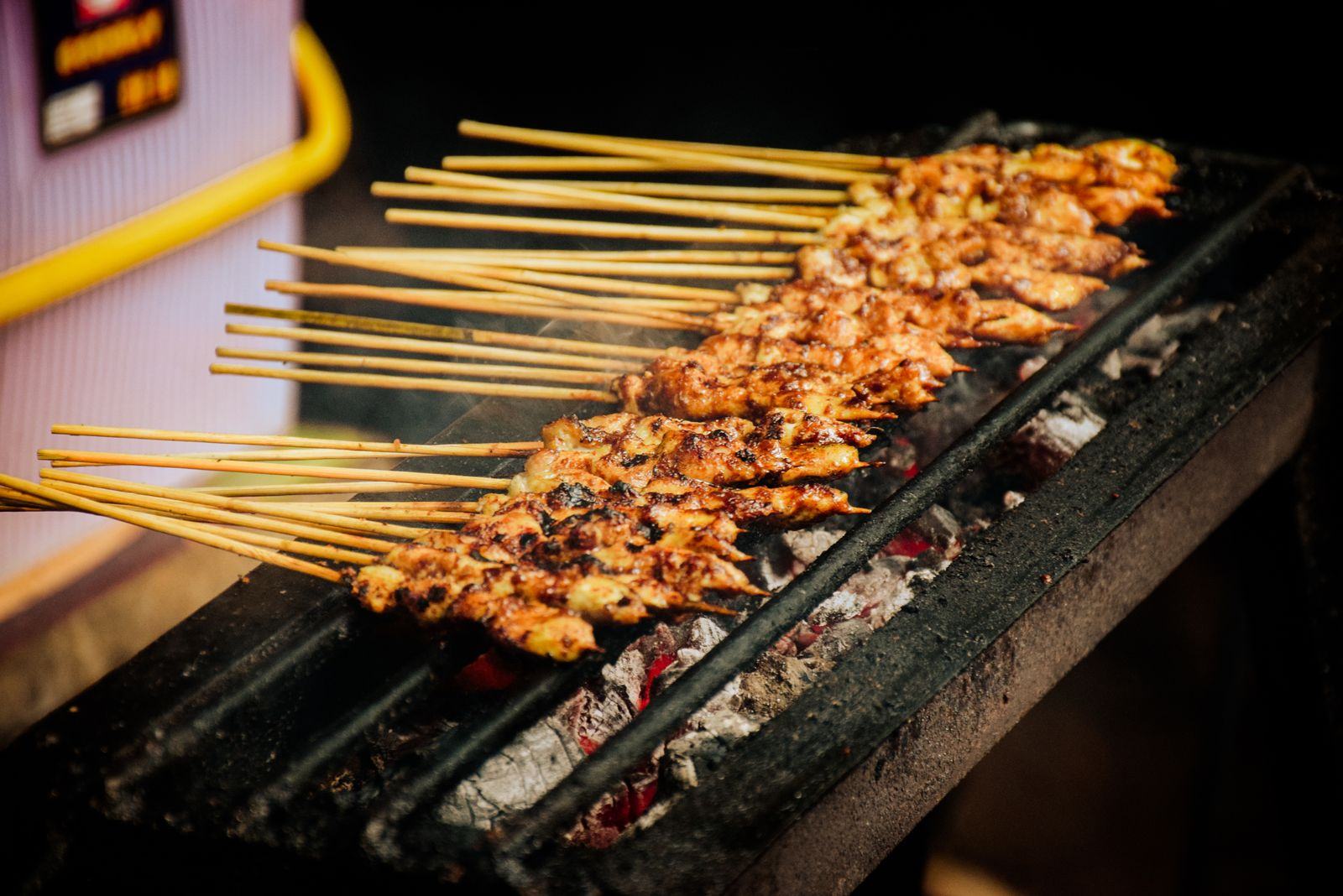 Satay skewers grilling over charcoal
